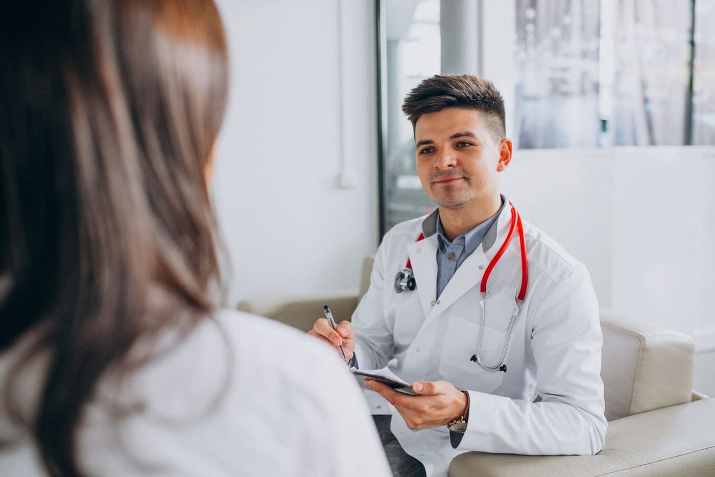 Physician and patient consultation reflecting specialty-specific billing workflows